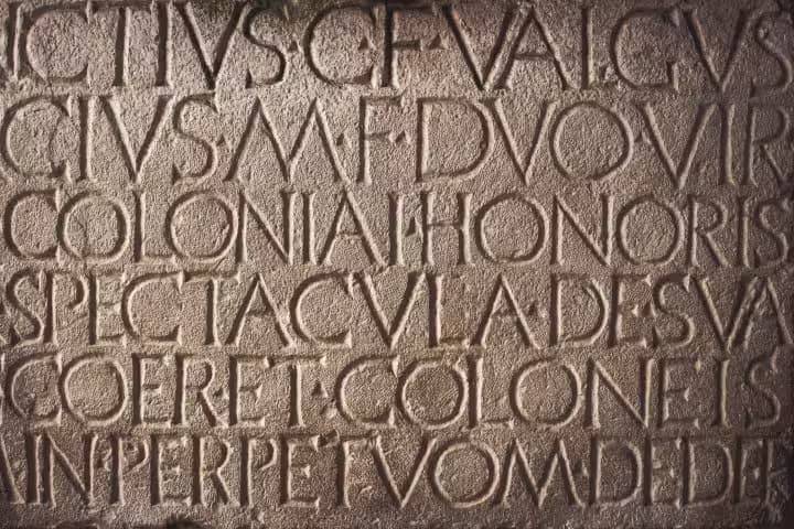 Image of roman letters carved into stone