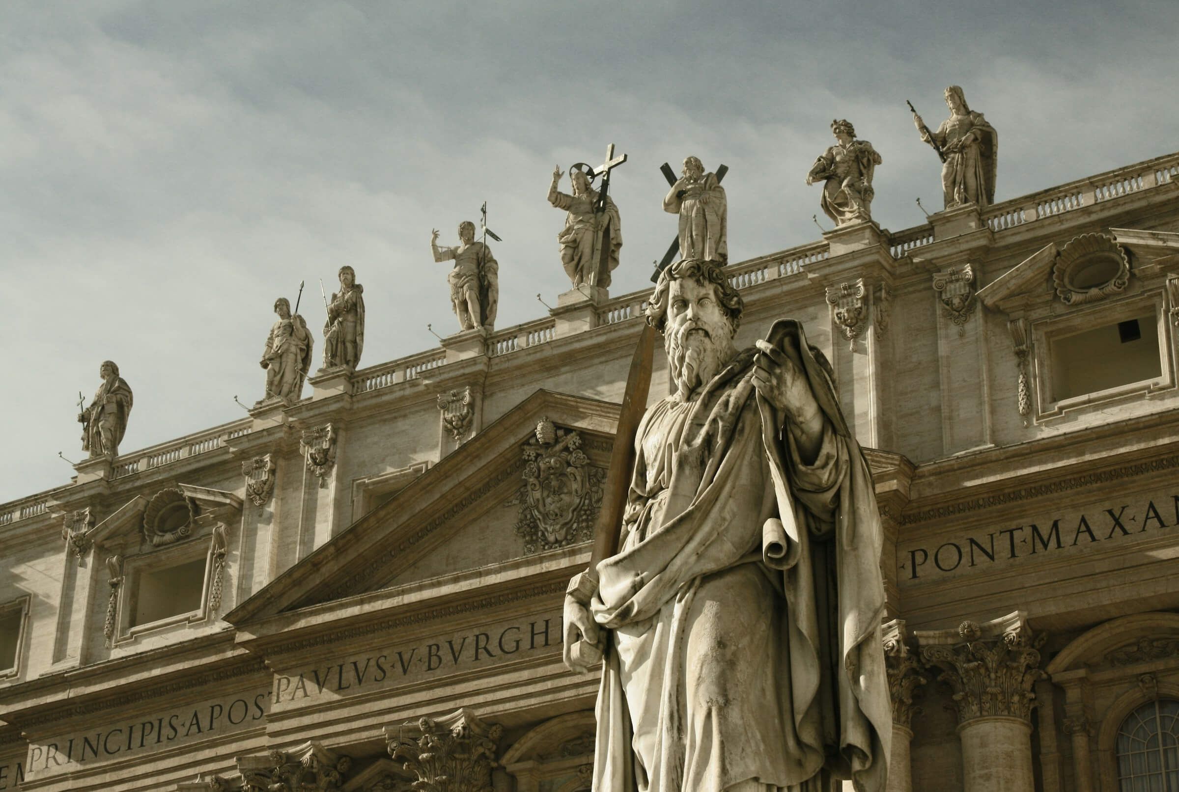 A statue in front of a Roman building